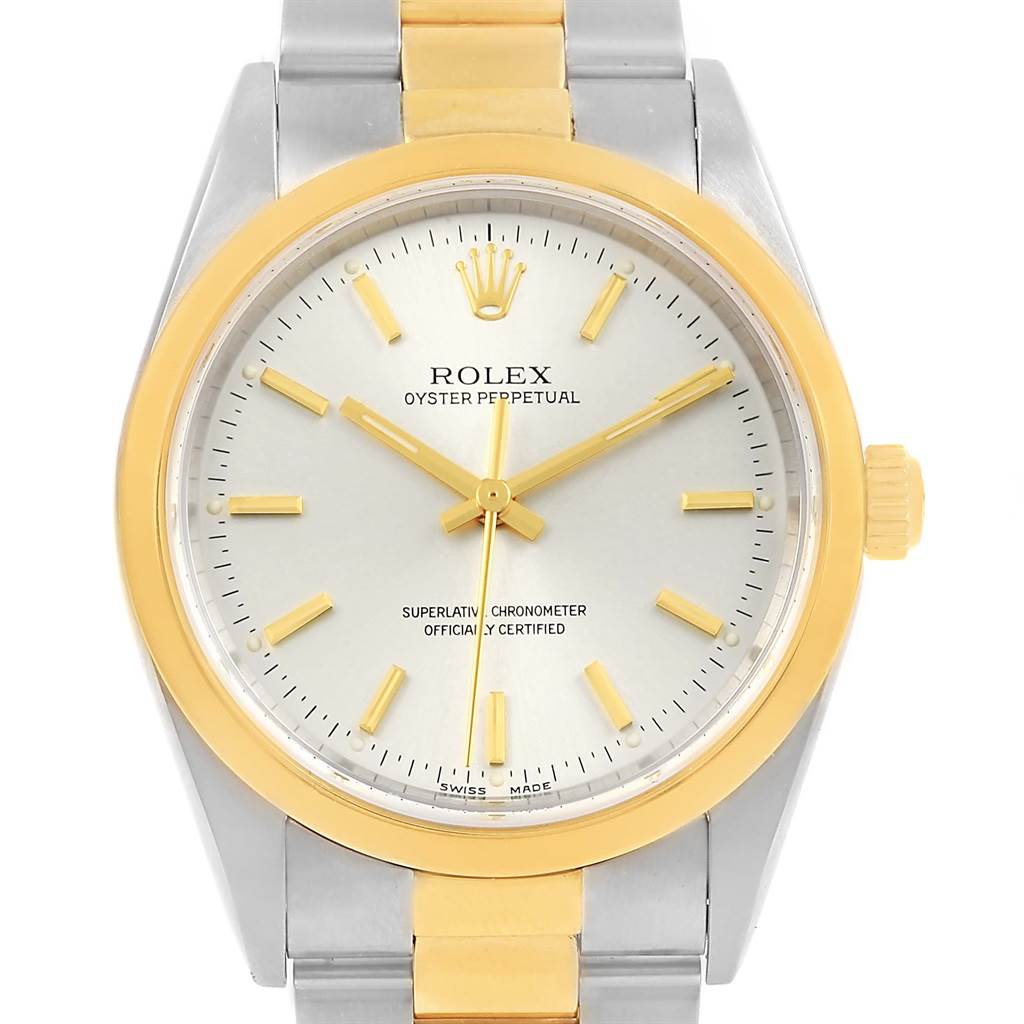 This image shows a front-facing angle of a Rolex Oyster Perpetual 14203 Men's Steel and Gold (two tone) Silver Dial 14203 Men's Steel and Gold (two tone) Silver Dial watch, highlighting its dial, bezel, and part of the bracelet.