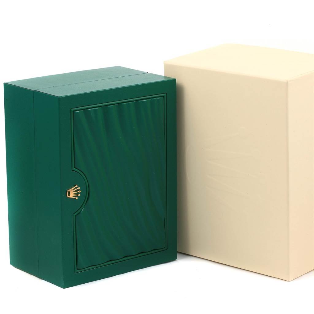 The image shows the green and beige packaging boxes for a Rolex Oyster Perpetual 114200 Men's Stainless Steel Blue Dial 114200 Men's Stainless Steel Blue Dial watch.