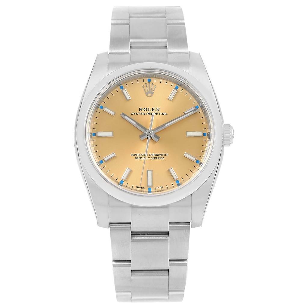 The image shows a Rolex Oyster Perpetual 114200 Men's Stainless Steel Champagne Dial 114200 Men's Stainless Steel Champagne Dial watch from a front view, highlighting its face, dial, and stainless steel bracelet.