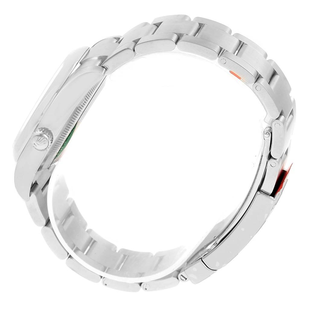 The image shows a side profile of a Rolex Oyster Perpetual 114200 Men's Stainless Steel Champagne Dial 114200 Men's Stainless Steel Champagne Dial watch, highlighting its crown, case, and bracelet.