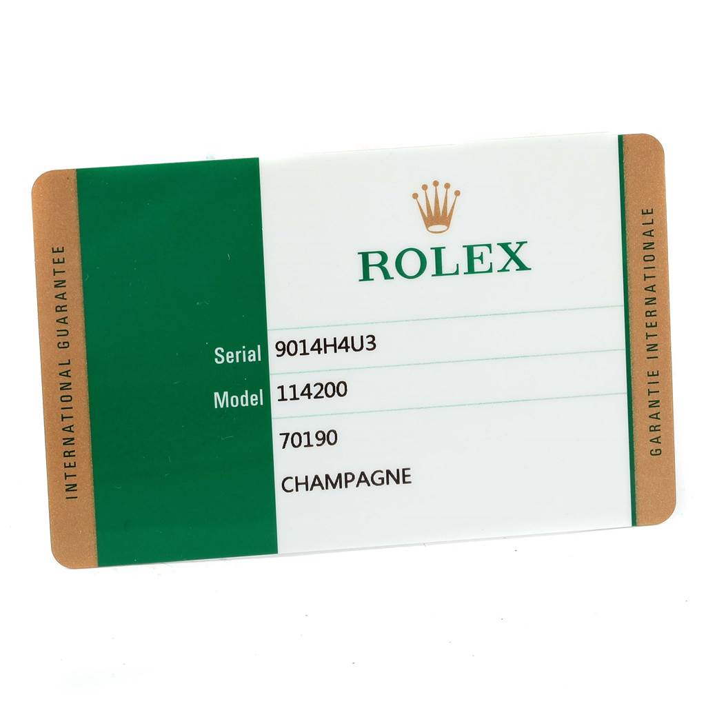This image shows the warranty card for a Rolex Oyster Perpetual 114200 Men's Stainless Steel Champagne Dial 114200 Men's Stainless Steel Champagne Dial model 114200 watch, displaying its serial number.