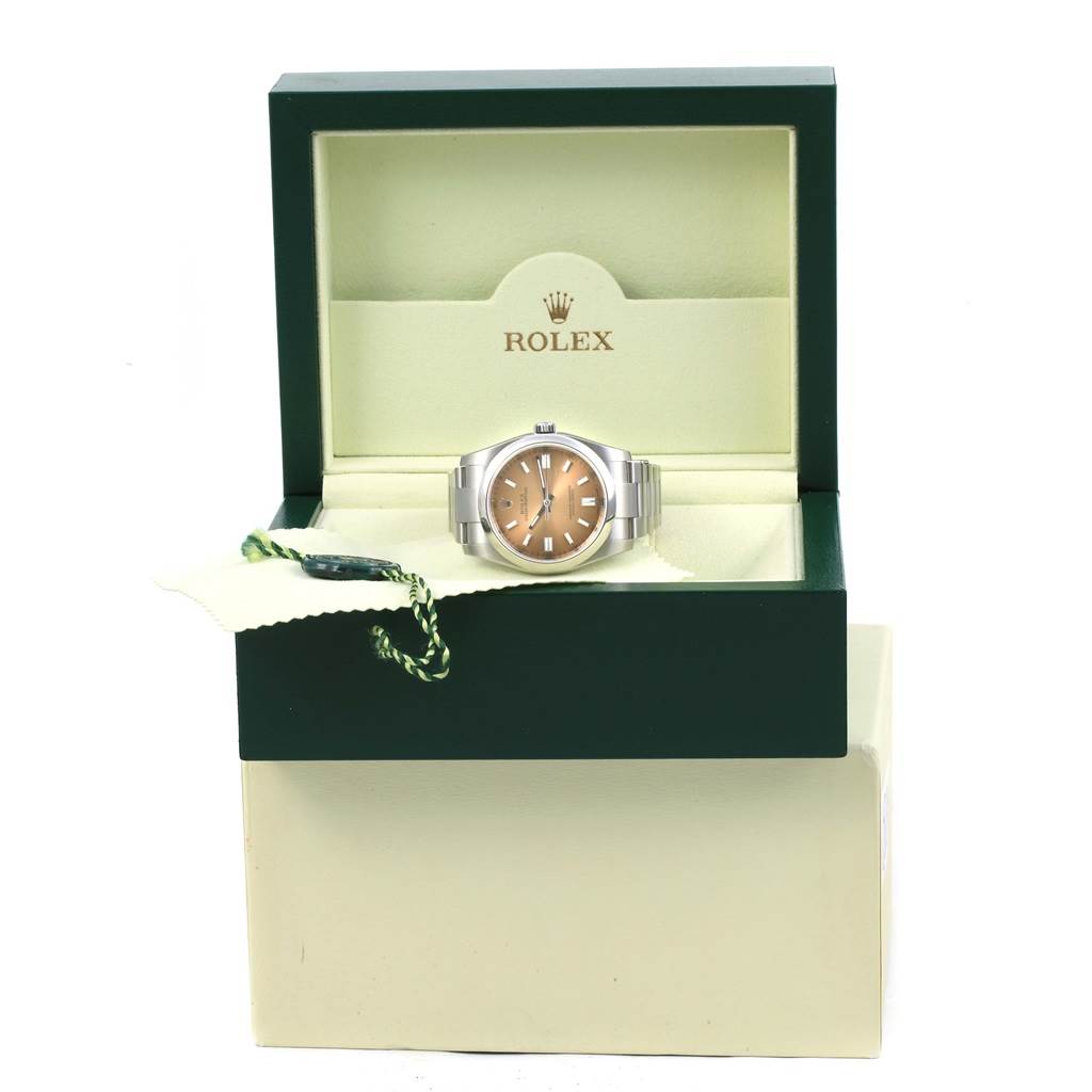 The photo shows a front view of the Rolex Oyster Perpetual 116000 Men's Stainless Steel Champagne Dial 116000 Men's Stainless Steel Champagne Dial watch inside an open Rolex box.