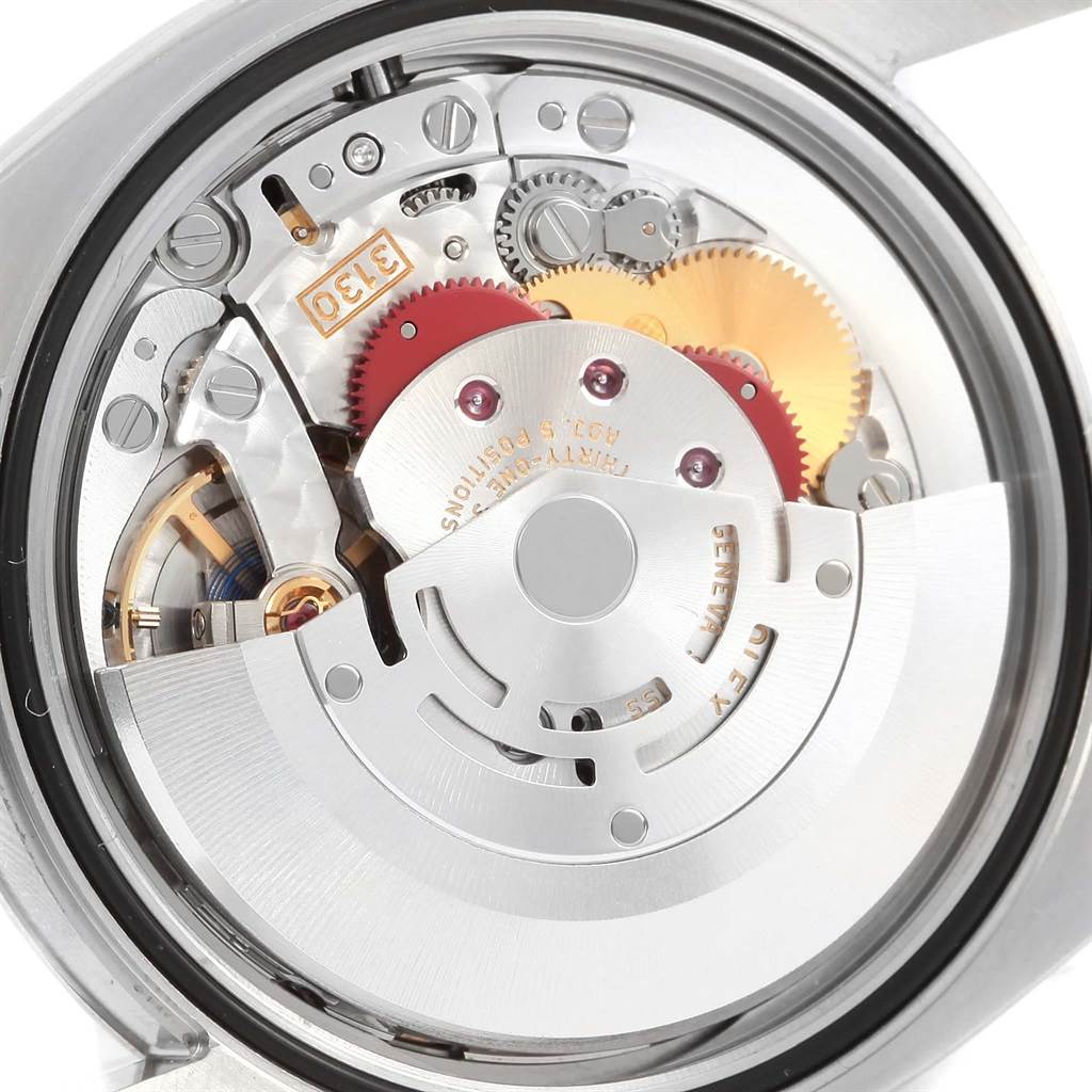 The image shows the inner mechanical movement of the Rolex Oyster Perpetual 116000 Men's Stainless Steel Champagne Dial 116000 Men's Stainless Steel Champagne Dial watch from a back angle, showcasing gears and the rotor.