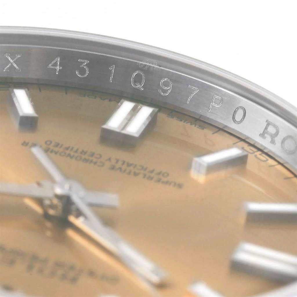 This close-up image shows the dial and rehaut of a Rolex Oyster Perpetual 116000 Men's Stainless Steel Champagne Dial 116000 Men's Stainless Steel Champagne Dial watch.