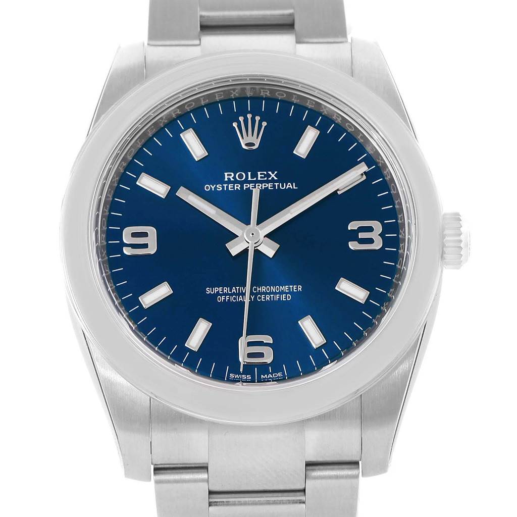 The image shows a Rolex Oyster Perpetual 114200 Men's Stainless Steel Blue Dial 114200 Men's Stainless Steel Blue Dial watch from a front angle, highlighting its blue dial, crown, and part of the bracelet.