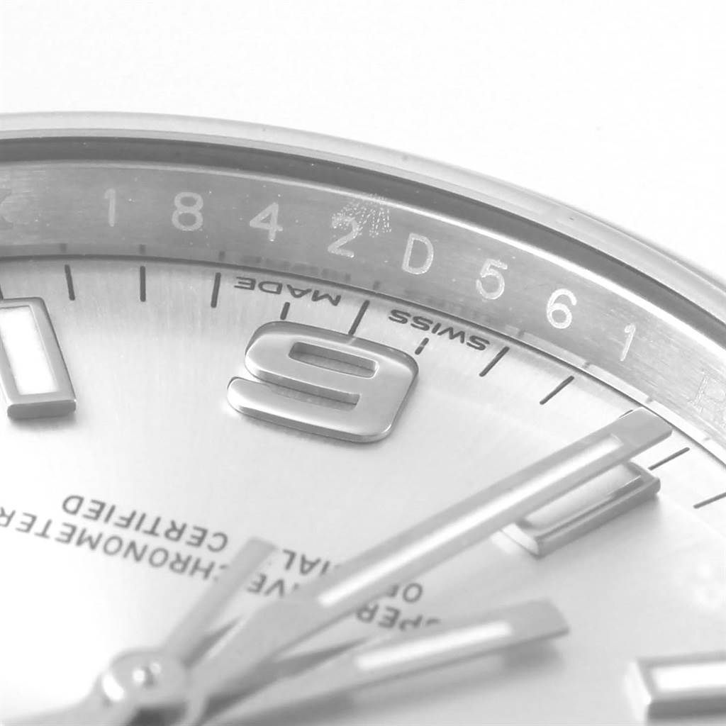 The image shows a close-up view of the dial, hands, and part of the bezel of a Rolex Oyster Perpetual 114200 Stainless Steel Silver Dial 114200 Stainless Steel Silver Dial watch.
