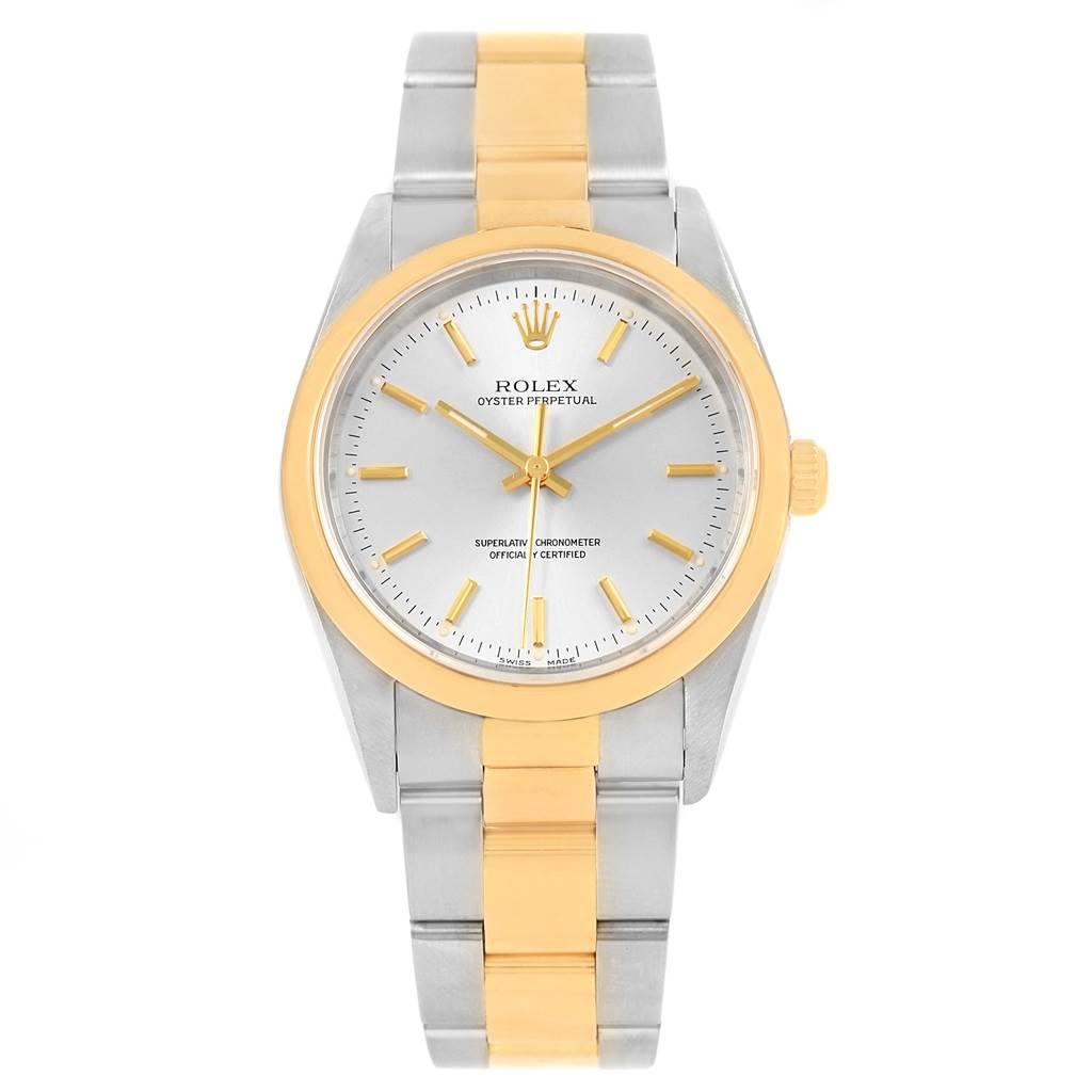 The Rolex Oyster Perpetual 14203 Men
s Steel and Gold (two tone) Silver Dial 14203 Men
s Steel and Gold (two tone) Silver Dial watch is shown from a front angle, highlighting its two-tone metal band and round face with gold accents.