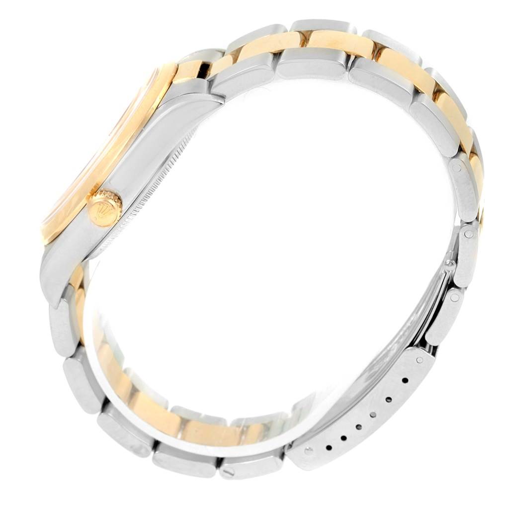 This image shows a side view of a Rolex Oyster Perpetual 14203 Men
s Steel and Gold (two tone) Silver Dial 14203 Men
s Steel and Gold (two tone) Silver Dial watch, featuring its two-tone bracelet and crown.