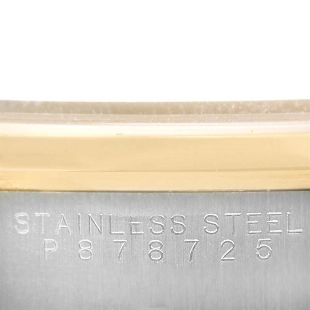 This close-up image shows the side of the case with "STAINLESS STEEL" engravings of the Rolex Oyster Perpetual 14203 Men
s Steel and Gold (two tone) Silver Dial 14203 Men
s Steel and Gold (two tone) Silver Dial watch.