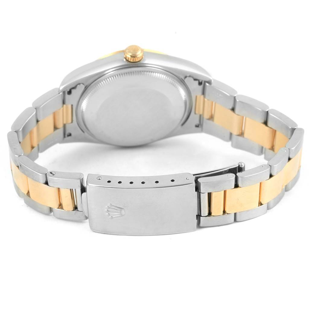 The image shows the back view of a Rolex Oyster Perpetual 14203 Men
s Steel and Gold (two tone) Silver Dial 14203 Men
s Steel and Gold (two tone) Silver Dial watch, including the case back, the bracelet, and the clasp.