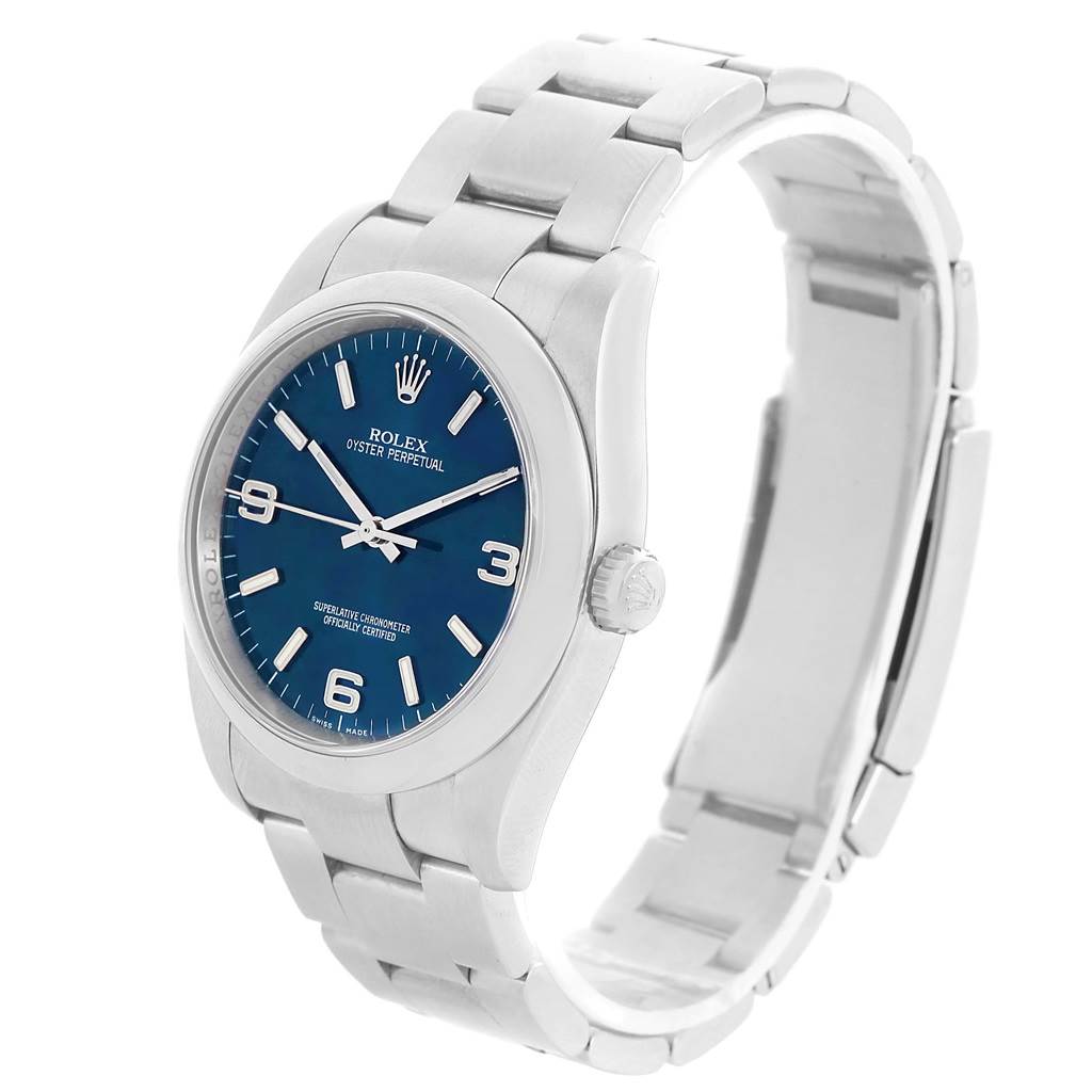 This is a Rolex Oyster Perpetual 116000 Men's Stainless Steel Blue Dial 116000 Men's Stainless Steel Blue Dial watch shown from a front-right angle, highlighting the blue dial and bracelet.