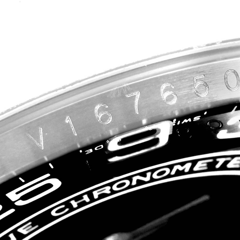 The image shows a close-up angle of the Rolex Oyster Perpetual 116000 Men's Stainless Steel Black Dial 116000 Men's Stainless Steel Black Dial watch's bezel, featuring engraved serial numbers.