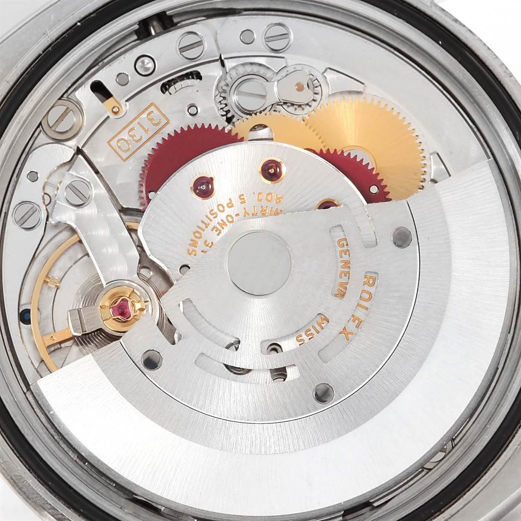 This image shows a close-up of the inner mechanism of a Rolex Oyster Perpetual 116000 Men's Stainless Steel Black Dial 116000 Men's Stainless Steel Black Dial watch, highlighting the gears and movement components.