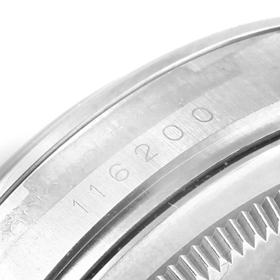 A close-up view of the case back and serial number engraving on a Rolex Oyster Perpetual 116200 Men's Stainless Steel Silver Dial 116200 Men's Stainless Steel Silver Dial 116200 watch.