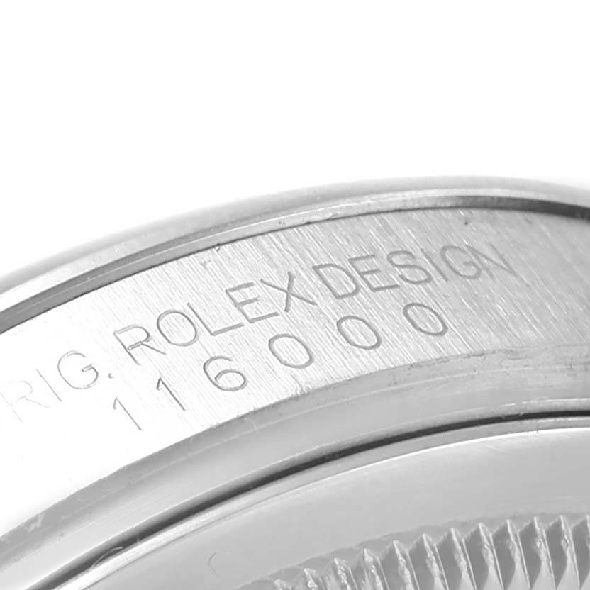 This image shows a close-up angle of the Rolex Oyster Perpetual 116000 Men's Stainless Steel Silver Dial 116000 Men's Stainless Steel Silver Dial model's case with the engraved model number "116000."
