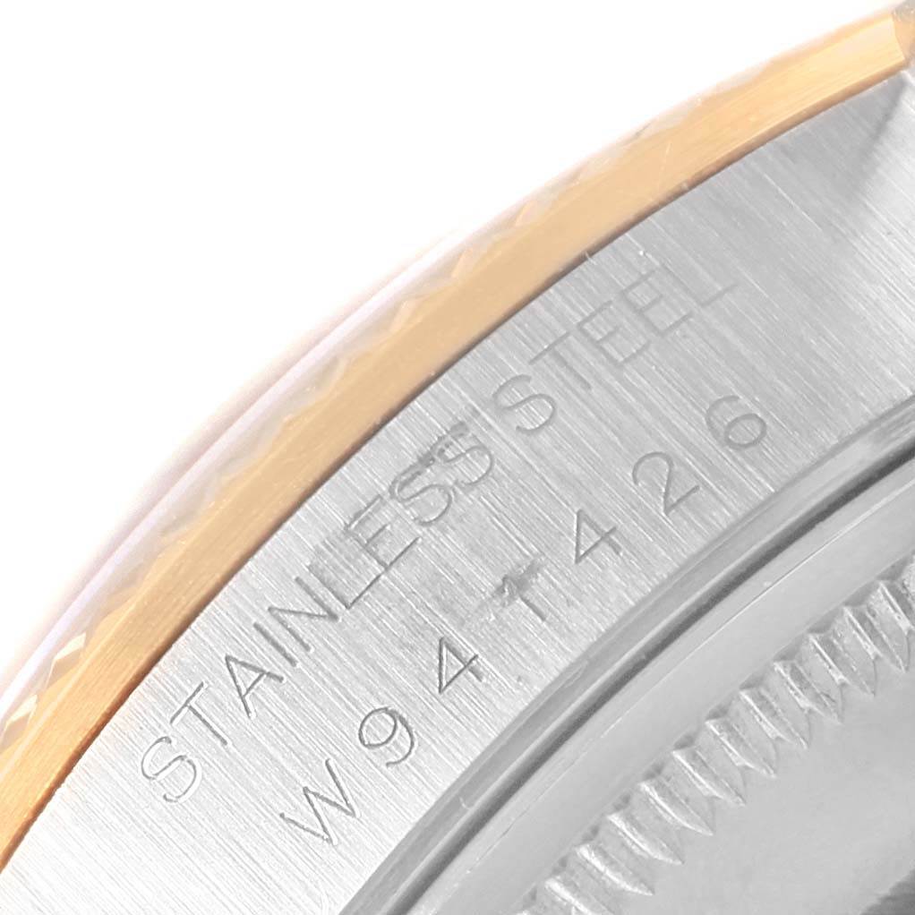 This image shows a close-up of the stainless steel and gold edge of a Rolex Oyster Perpetual 14233 Men's Steel and Gold (two tone) Champagne Dial 14233 Men's Steel and Gold (two tone) Champagne Dial watch, focusing on the engraved text and part of the bezel.