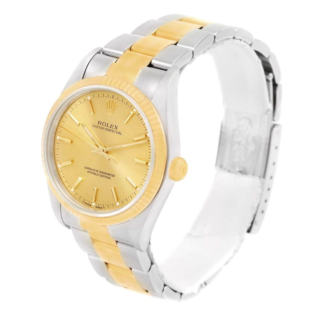 The image shows a Rolex Oyster Perpetual 14233 Men's Steel and Gold (two tone) Champagne Dial 14233 Men's Steel and Gold (two tone) Champagne Dial watch at an angle displaying the dial, bezel, case, and part of the bracelet.