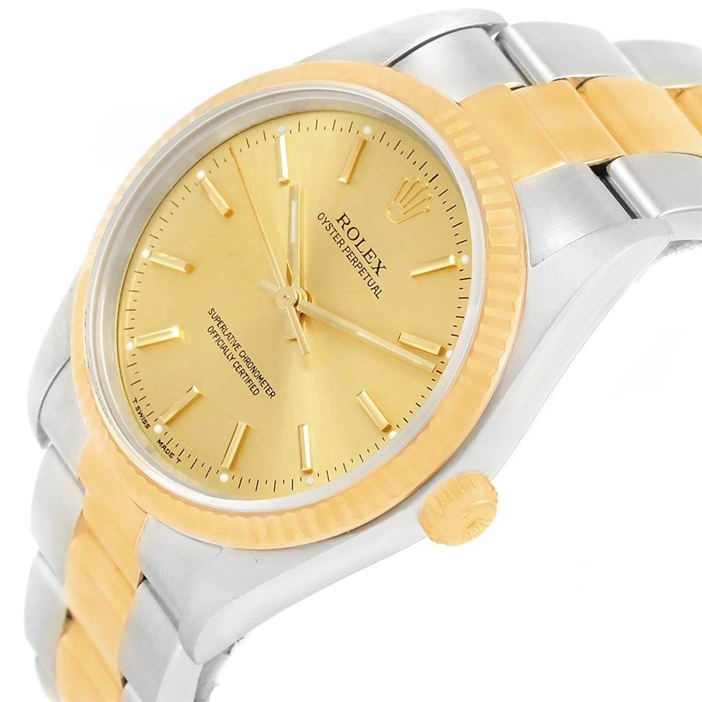 The Rolex Oyster Perpetual 14233 Men's Steel and Gold (two tone) Champagne Dial 14233 Men's Steel and Gold (two tone) Champagne Dial watch is shown at a slight angle, highlighting the dial, bezel, crown, and part of the bracelet.