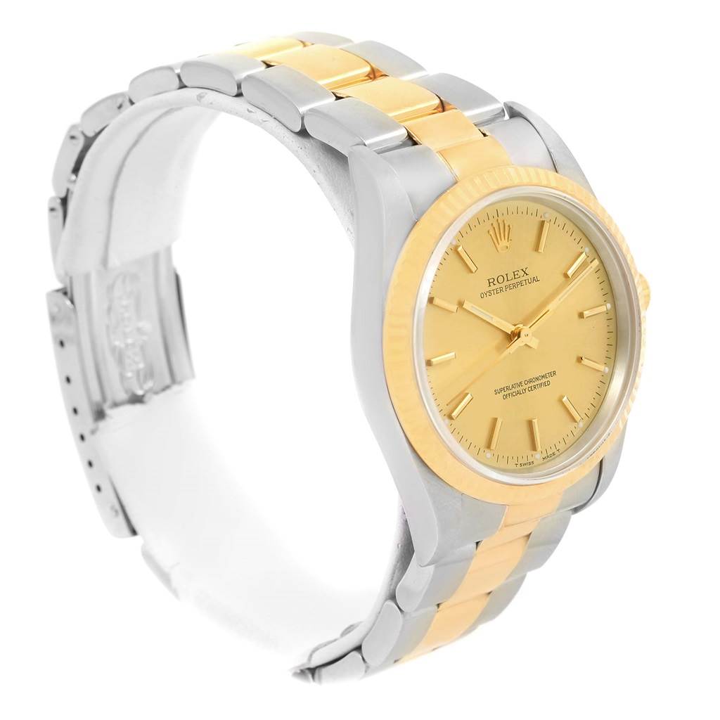 The image shows a side angle view of the Rolex Oyster Perpetual 14233 Men's Steel and Gold (two tone) Champagne Dial 14233 Men's Steel and Gold (two tone) Champagne Dial watch, highlighting its gold and silver bracelet and gold dial.