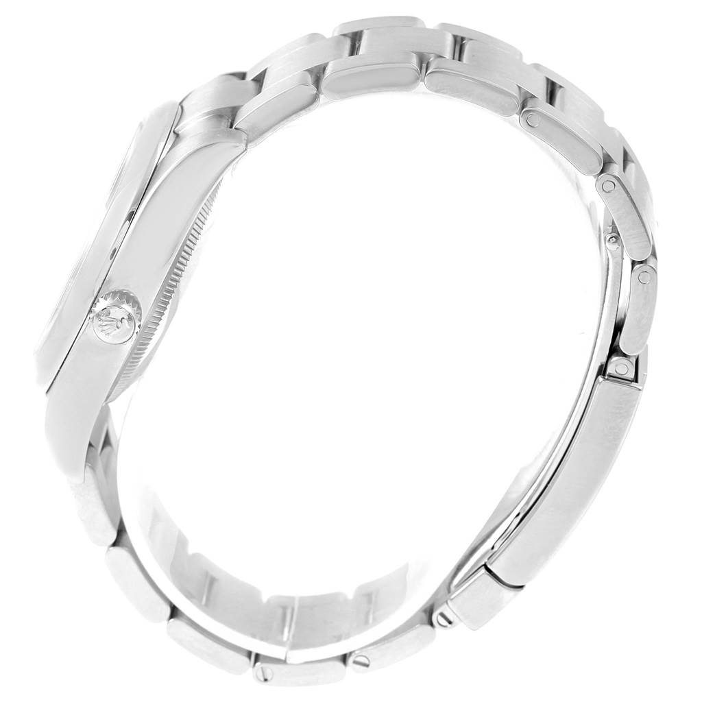 This image shows the side profile of the Rolex Oyster Perpetual 114200 Stainless Steel Champagne Dial 114200 Stainless Steel Champagne Dial watch, highlighting its crown and bracelet links.