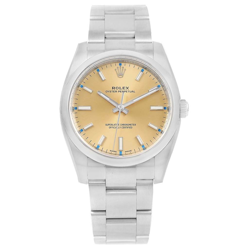 The image shows a front view of a Rolex Oyster Perpetual 114200 Stainless Steel Champagne Dial 114200 Stainless Steel Champagne Dial watch, displaying the face, bezel, crown, and bracelet.