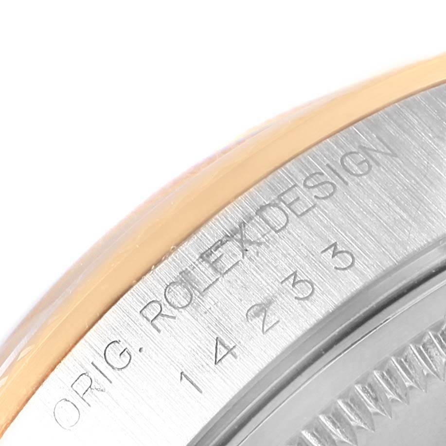 This close-up image shows the edge of a Rolex Oyster Perpetual 14233 Men's Steel and Gold (two tone) Champagne Dial 14233 Men's Steel and Gold (two tone) Champagne Dial case, displaying the "ORIG. ROLEX DESIGN" engraving and part of the case back.