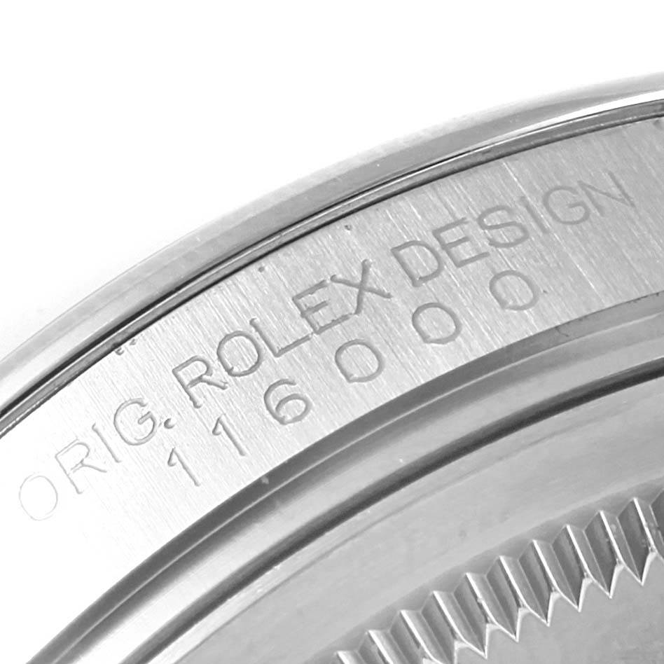 A close-up of the engraved case back rim of a Rolex Oyster Perpetual 116000 Stainless Steel Grey Dial 116000 Stainless Steel Grey Dial watch, displaying model and design details.