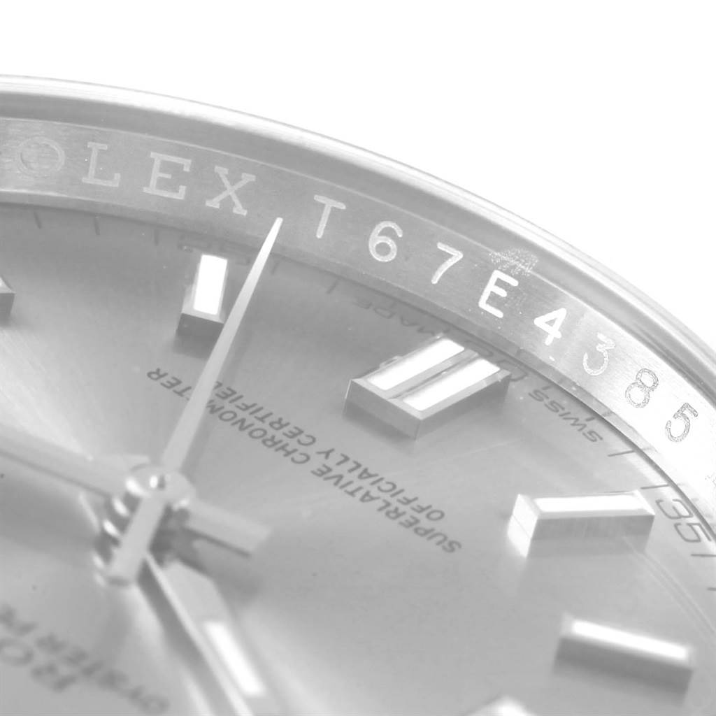 The image shows a close-up angle of the dial and part of the bezel of a Rolex Oyster Perpetual 116000 Stainless Steel Grey Dial 116000 Stainless Steel Grey Dial watch.