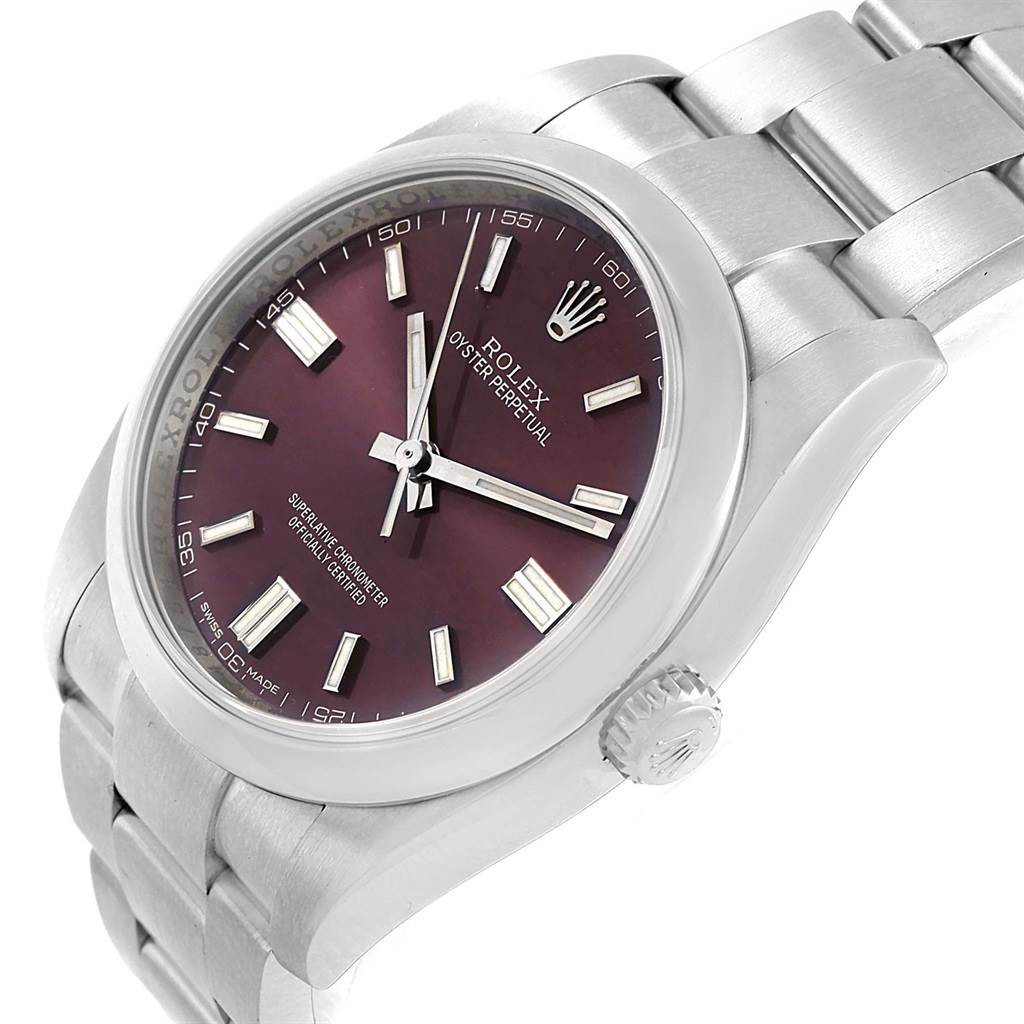 The Rolex Oyster Perpetual 116000 Stainless Steel Burgundy Dial 116000 Stainless Steel Burgundy Dial watch is shown at an angle, highlighting the burgundy dial, stainless steel case, bracelet, and crown.