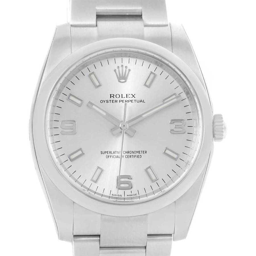 The image displays a front view of the Rolex Oyster Perpetual watch, showing the face, dial, hands, and part of the metal bracelet.