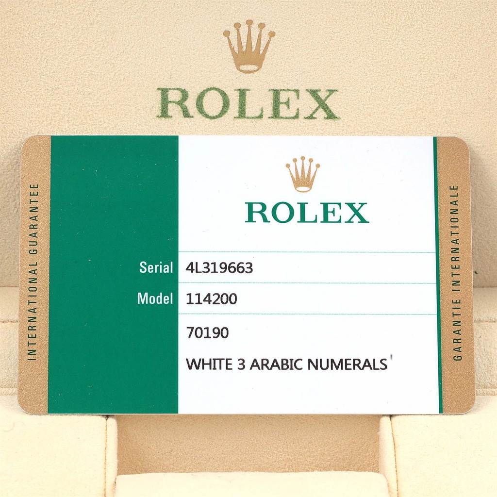 This image shows the warranty card for the Rolex Oyster Perpetual 114200 Stainless Steel White Dial 114200 Stainless Steel White Dial model 114200, displaying the serial number and model details.