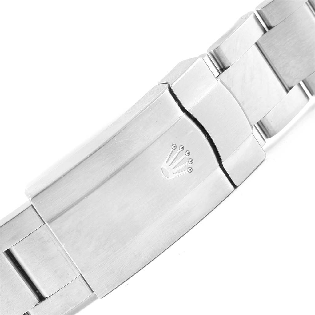 This image shows a close-up view of the clasp on a Rolex Oyster Perpetual 114300 Stainless Steel Burgundy Dial 114300 Stainless Steel Burgundy Dial bracelet, featuring the brand's logo.