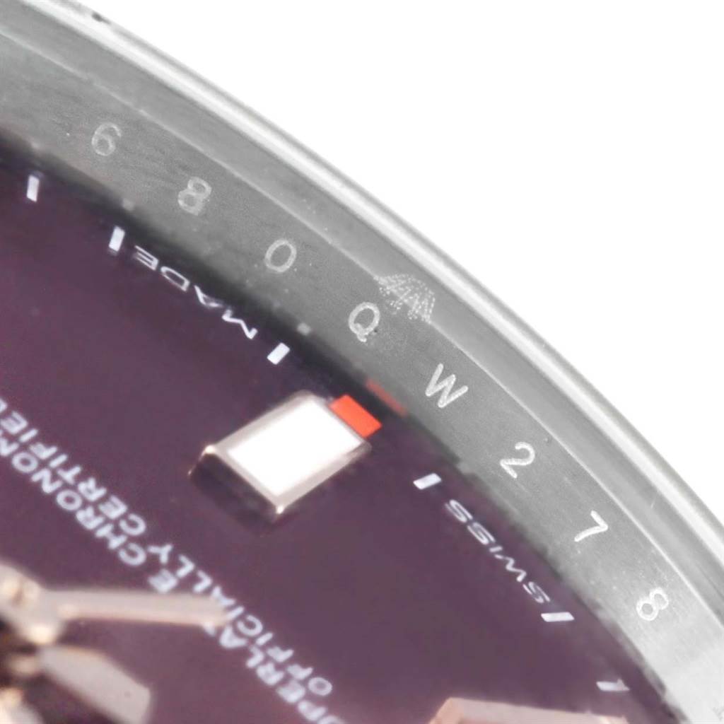 The image shows a close-up of the dial and chapter ring of a Rolex Oyster Perpetual 114300 Stainless Steel Burgundy Dial 114300 Stainless Steel Burgundy Dial watch.