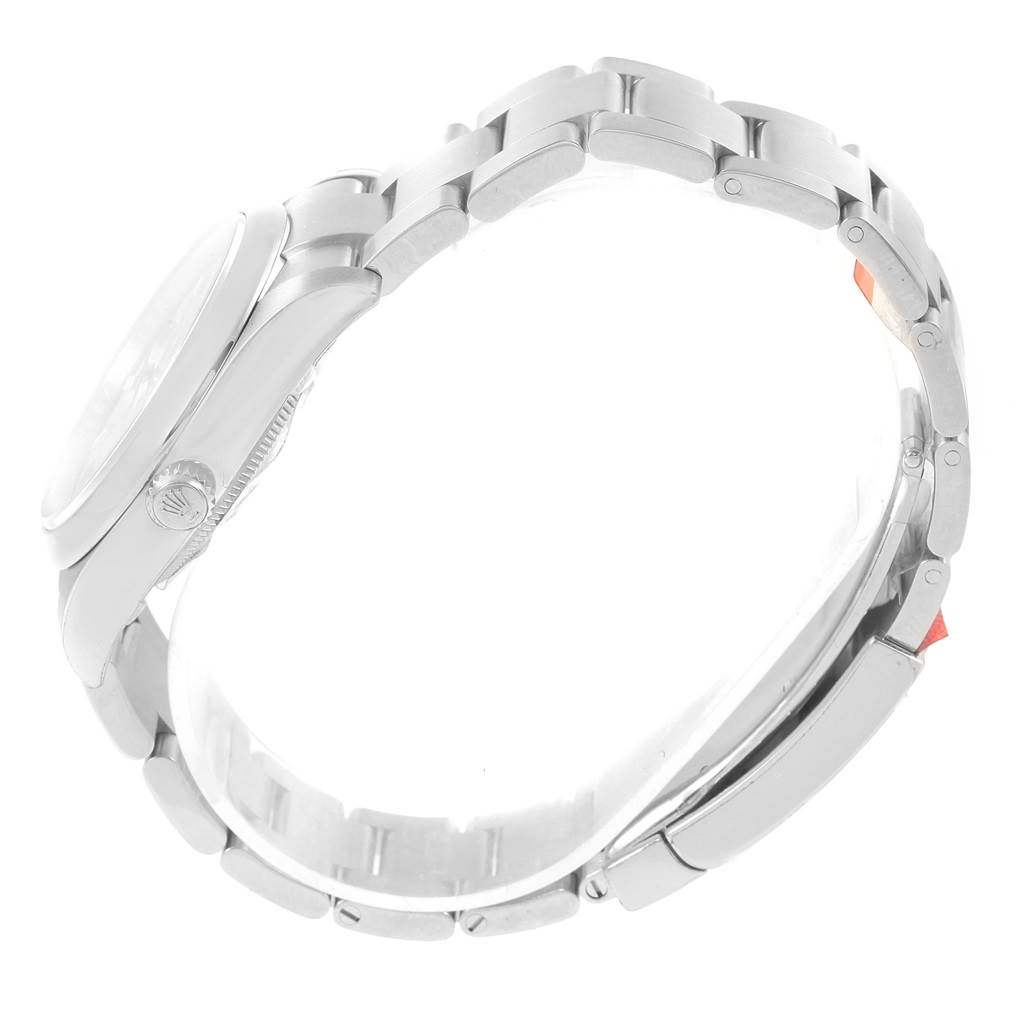 The Rolex Oyster Perpetual 114200 Stainless Steel Silver Dial 114200 Stainless Steel Silver Dial watch is shown from a side angle, highlighting the case, crown, and bracelet.