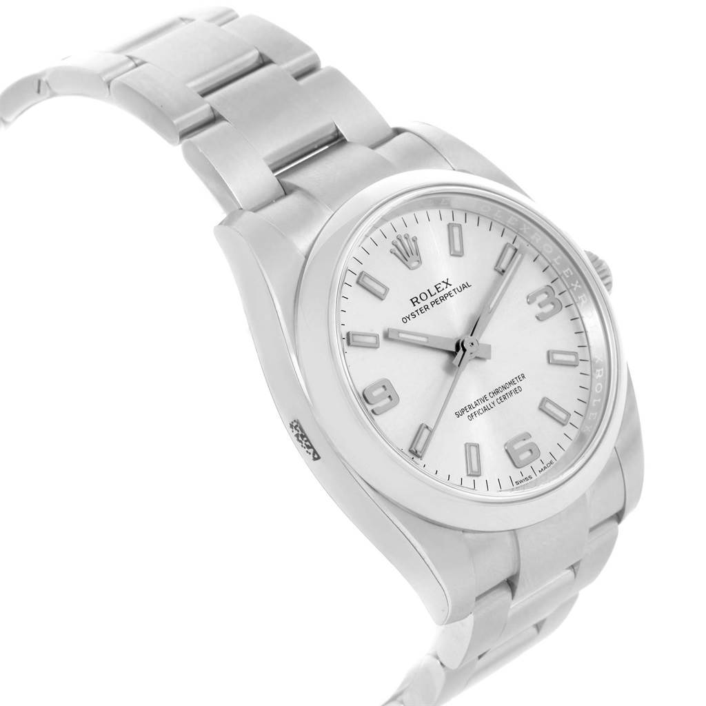 The image shows a Rolex Oyster Perpetual 114200 Stainless Steel Silver Dial 114200 Stainless Steel Silver Dial watch at a slight angle, highlighting the face, bezel, and part of the bracelet.