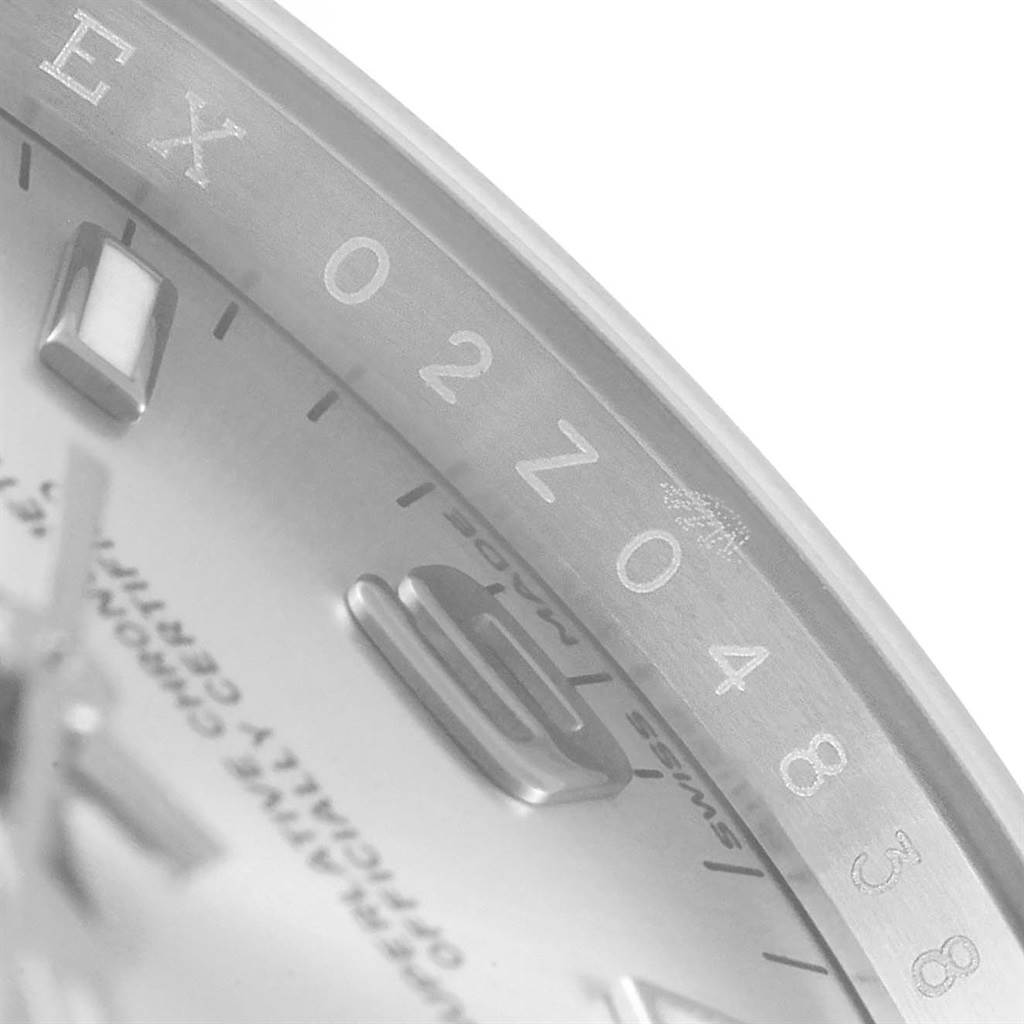 The image shows a close-up angle of a Rolex Oyster Perpetual 114200 Stainless Steel Silver Dial 114200 Stainless Steel Silver Dial watch, focusing on the dial, hour markers, and part of the chapter ring.