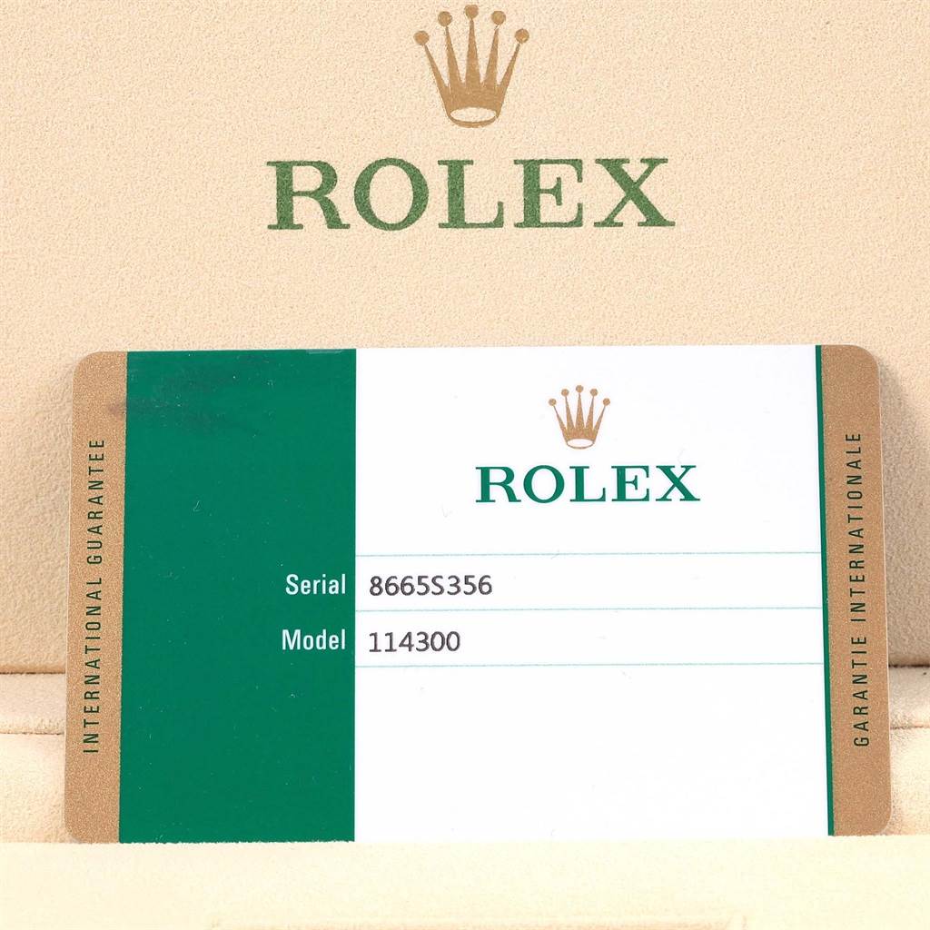 This image shows the warranty card for the Rolex Oyster Perpetual 114300 Stainless Steel Burgundy Dial 114300 Stainless Steel Burgundy Dial Model 114300, indicating the serial number 8665S356.