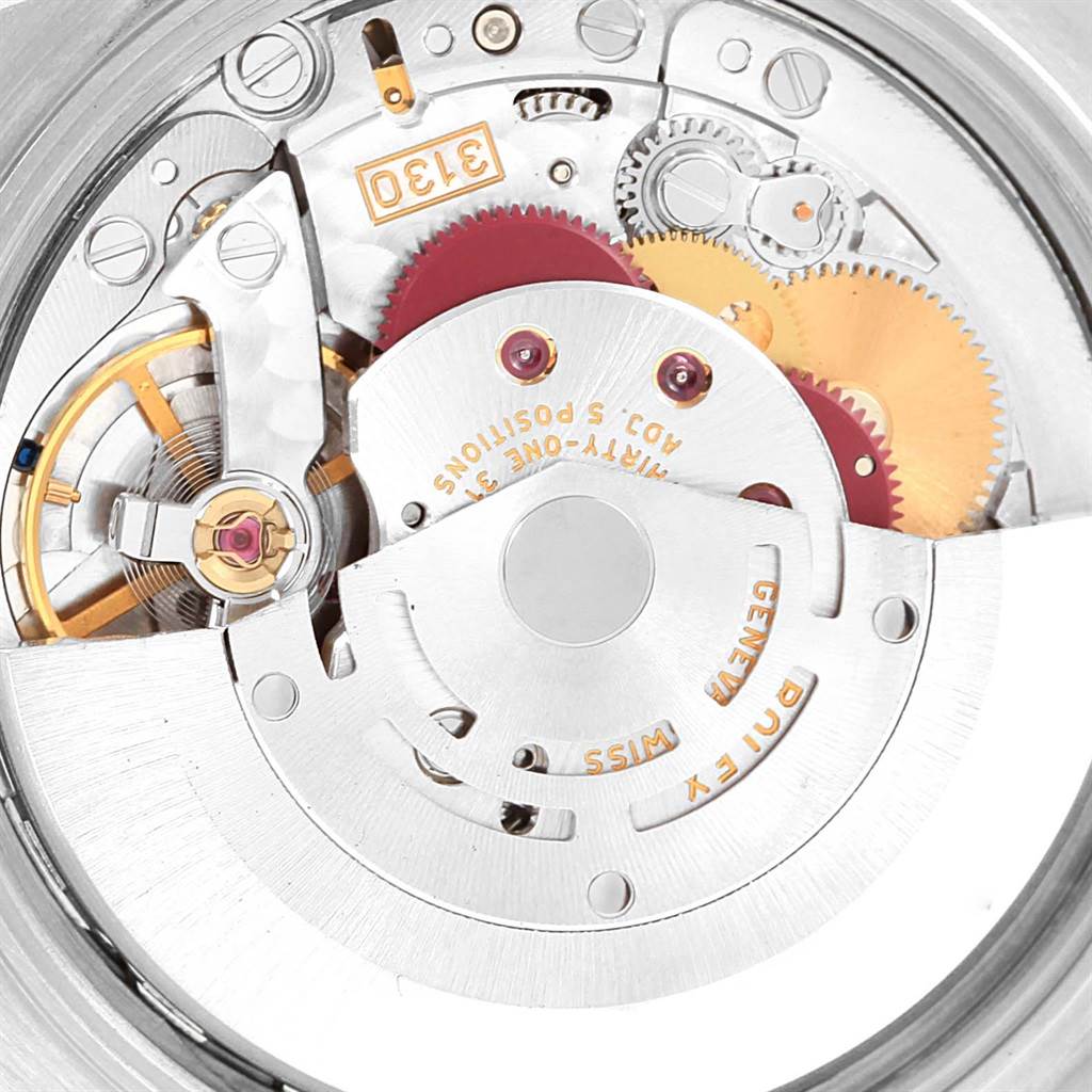 This image shows a close-up of the internal mechanism of a Rolex Oyster Perpetual 14203 Steel and Gold (two tone) Silver Dial 14203 Steel and Gold (two tone) Silver Dial watch, focusing on the gears and movement components.