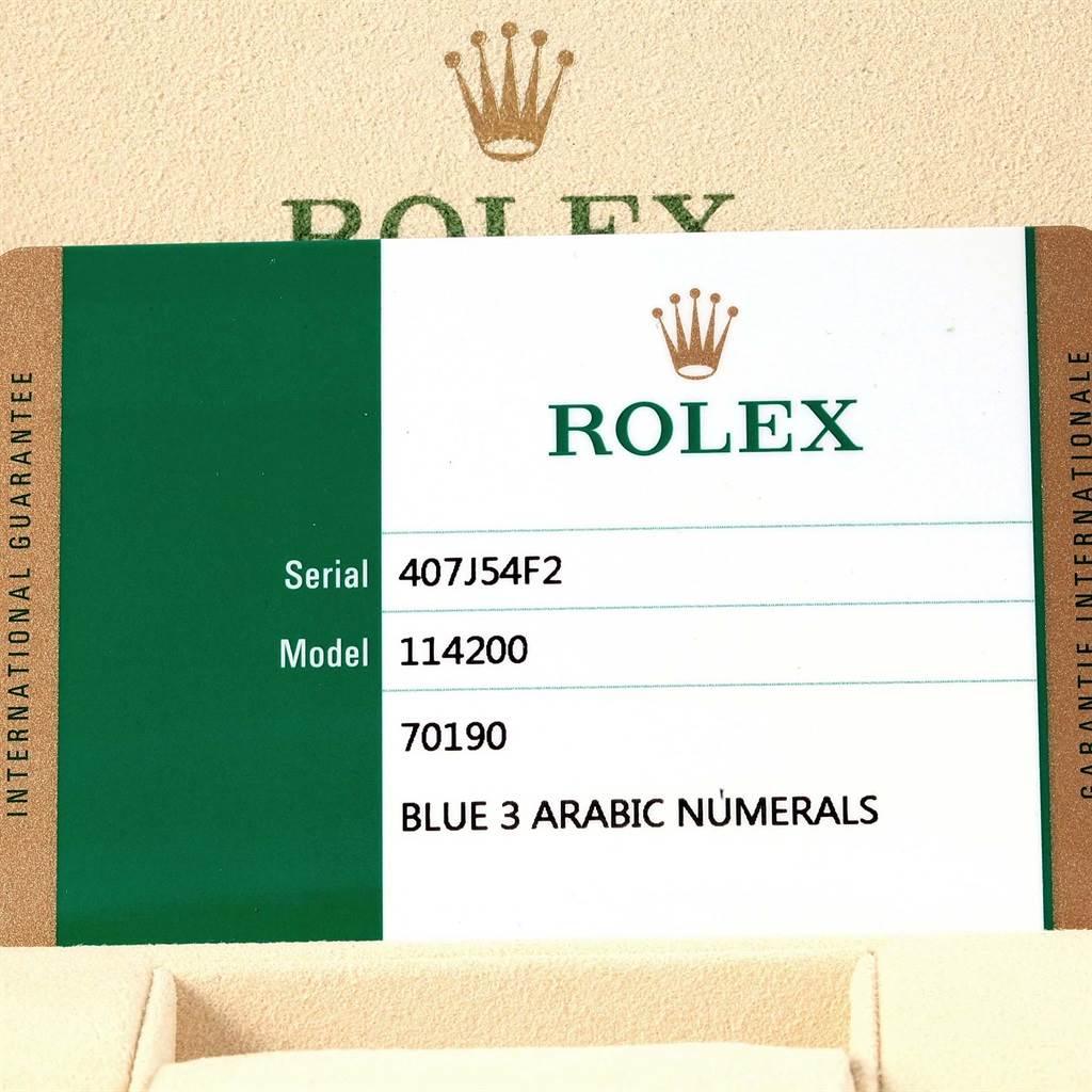 This image shows the warranty card for a Rolex Oyster Perpetual 114200 Men's Stainless Steel Blue Dial 114200 Men's Stainless Steel Blue Dial model 114200, including the serial number and special features.