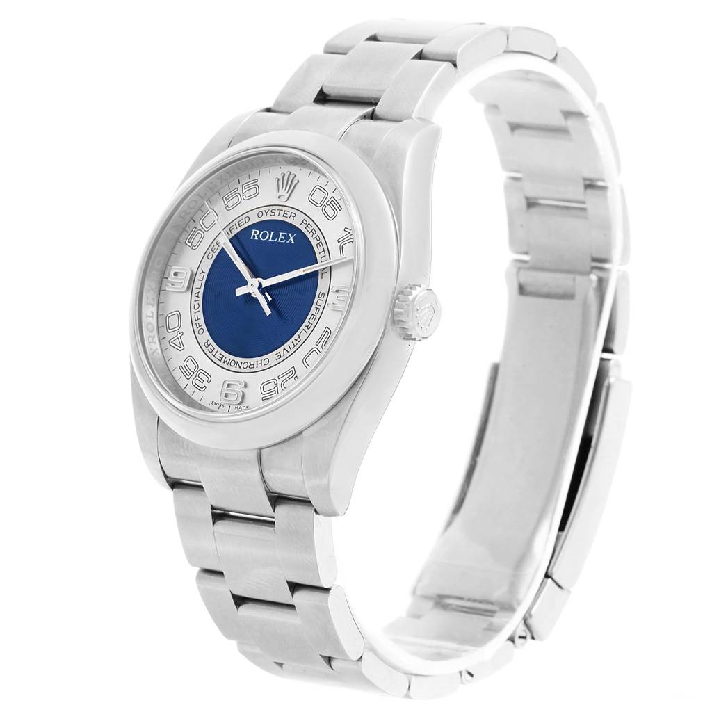 The Rolex Oyster Perpetual 116000 Men's Stainless Steel Silver Dial 116000 Men's Stainless Steel Silver Dial watch is shown at a slight angle, displaying the face, bezel, and partially open bracelet.