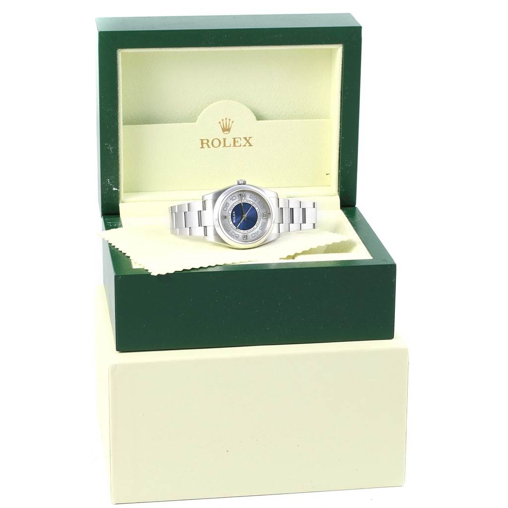 The Rolex Oyster Perpetual 116000 Men's Stainless Steel Silver Dial 116000 Men's Stainless Steel Silver Dial watch is shown from the front inside its open display box.