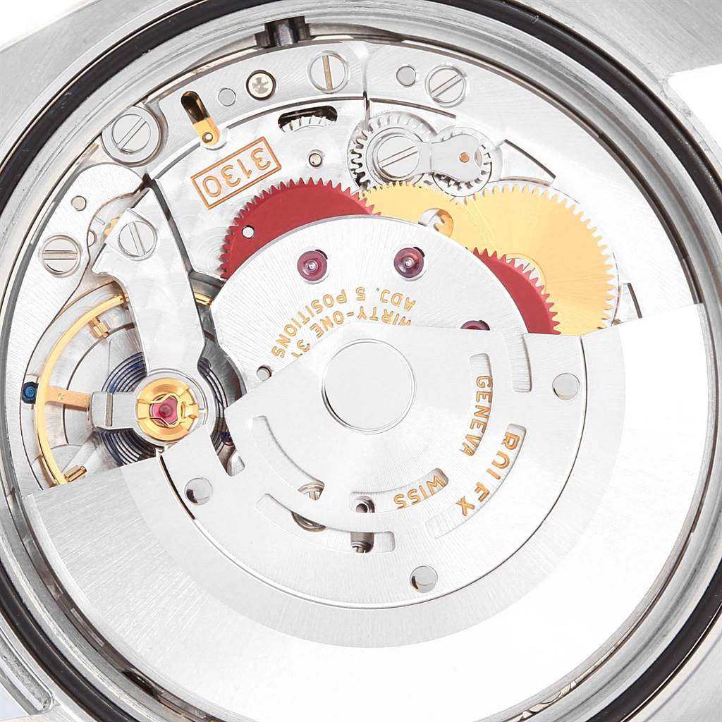 The image shows a close-up view of the movement and internal mechanical parts of a Rolex Oyster Perpetual 116000 Men's Stainless Steel Blue Dial 116000 Men's Stainless Steel Blue Dial watch.