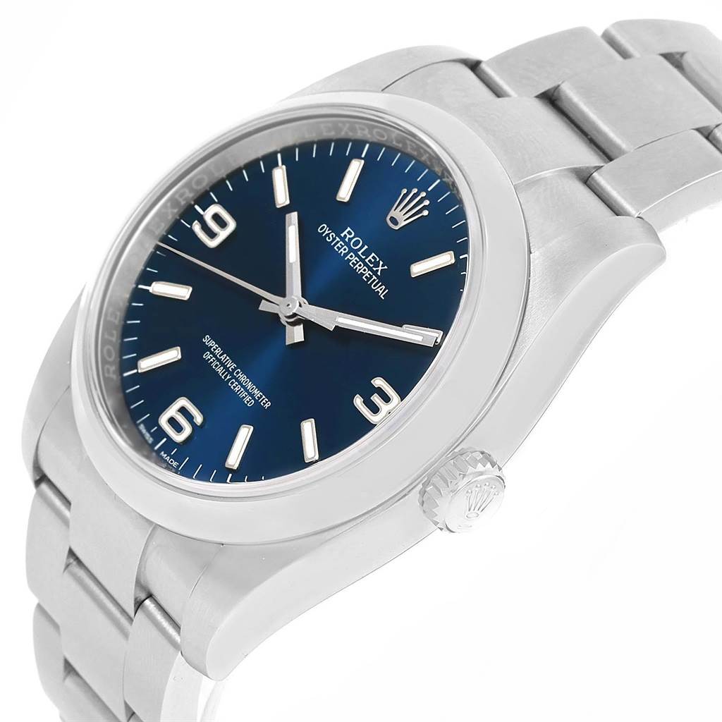 The image shows a Rolex Oyster Perpetual 116000 Men's Stainless Steel Blue Dial 116000 Men's Stainless Steel Blue Dial watch at a slight angle, highlighting the dial, crown, and bracelet.
