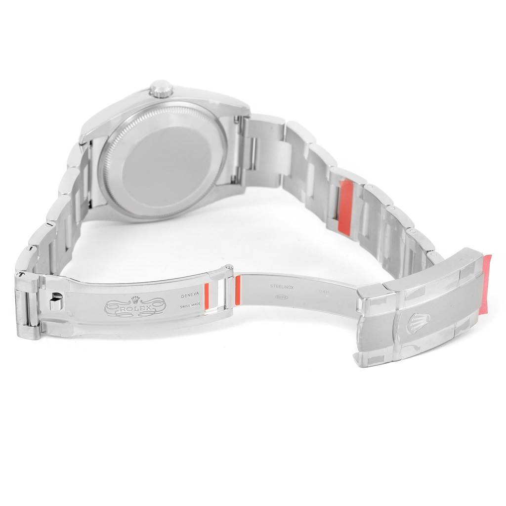 The image shows the back of a Rolex Oyster Perpetual 114200 Men's Stainless Steel Blue Dial 114200 Men's Stainless Steel Blue Dial watch, highlighting the open clasp and stainless steel bracelet.