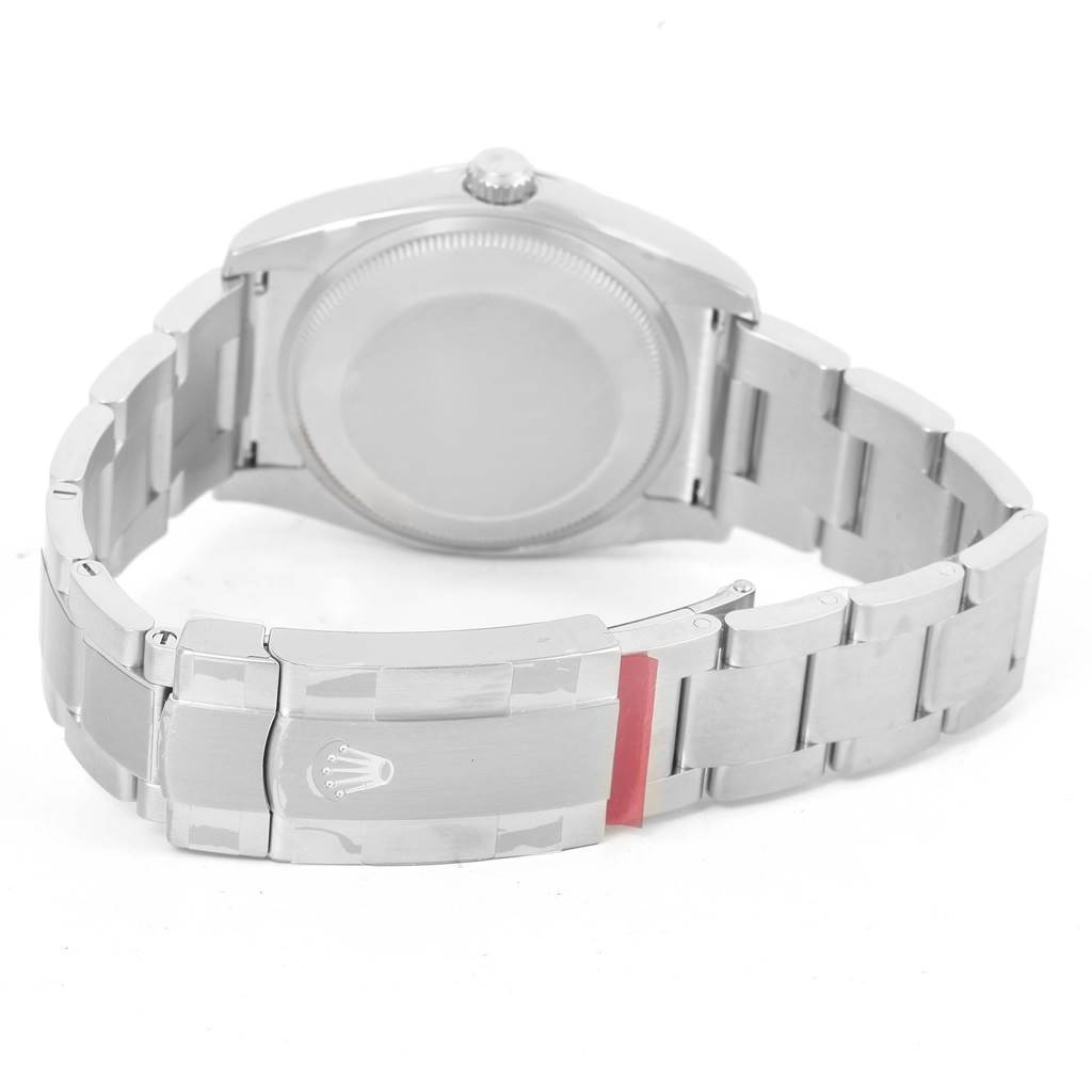 The Rolex Oyster Perpetual 114200 Men's Stainless Steel Blue Dial 114200 Men's Stainless Steel Blue Dial watch is shown from the back, highlighting the clasp, bracelet, and the case back.