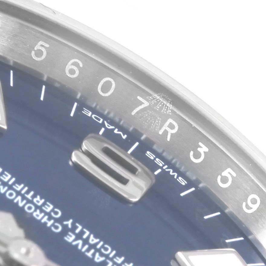 This close-up angle of the Rolex Oyster Perpetual 114200 Men's Stainless Steel Blue Dial 114200 Men's Stainless Steel Blue Dial watch shows the edge of the dial and the inner bezel.