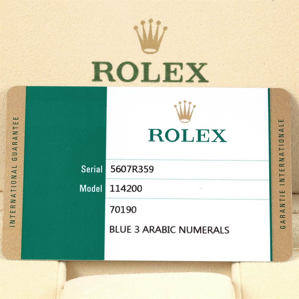 The image shows the warranty card for a Rolex Oyster Perpetual 114200 Men's Stainless Steel Blue Dial 114200 Men's Stainless Steel Blue Dial model 114200 with serial number 5607R359, featuring blue 3 Arabic numerals.