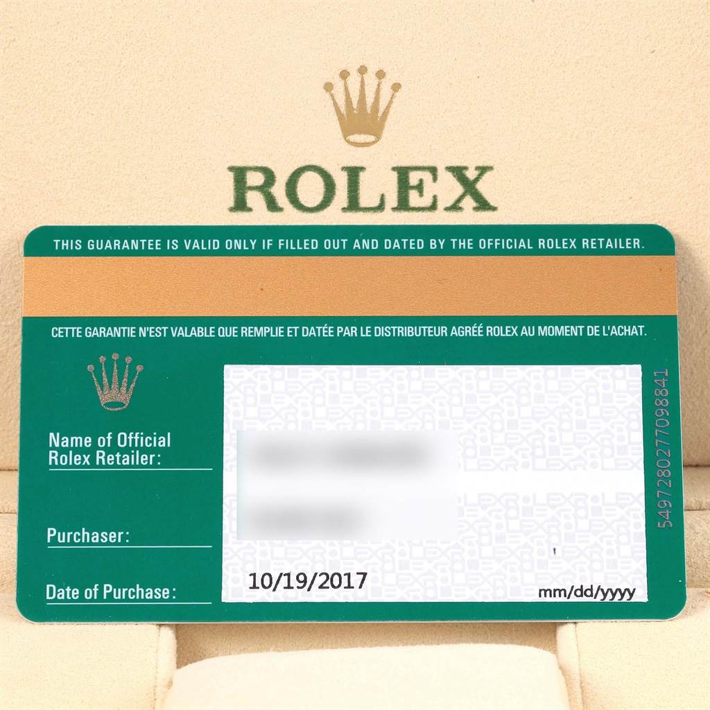 This image shows a warranty card for a Rolex Oyster Perpetual 114200 Men's Stainless Steel Blue Dial 114200 Men's Stainless Steel Blue Dial watch, including retailer and purchase date details.