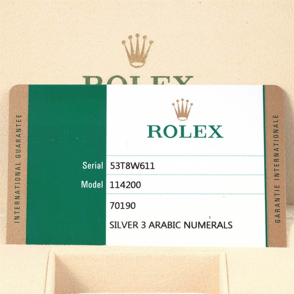 The image shows the guarantee and information card for the Rolex Oyster Perpetual 114200 Stainless Steel Silver Dial 114200 Stainless Steel Silver Dial model, including its serial and model number.