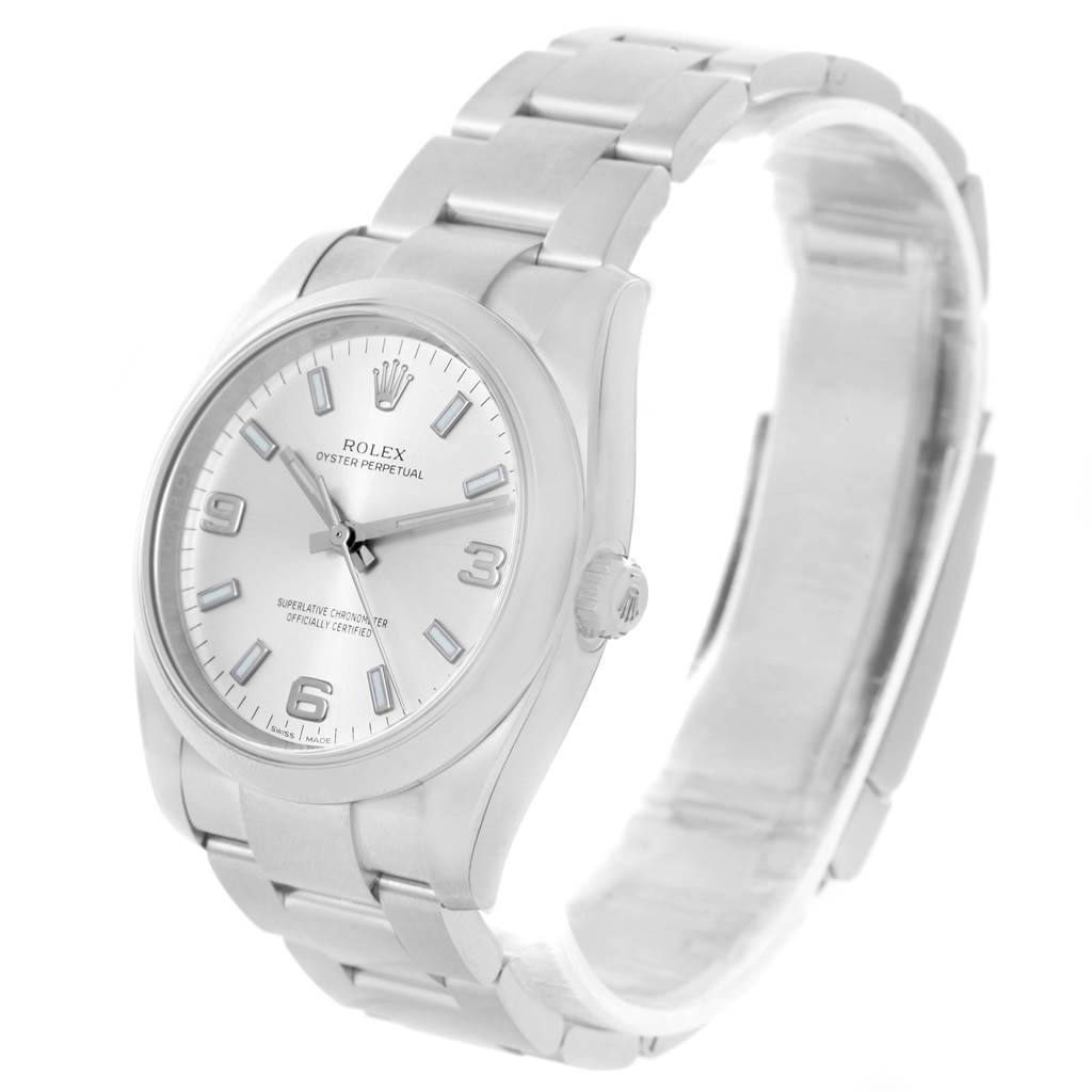 The Rolex Oyster Perpetual 114200 Stainless Steel Silver Dial 114200 Stainless Steel Silver Dial watch is shown from a slightly angled side view, displaying the face, bezel, and part of the bracelet.